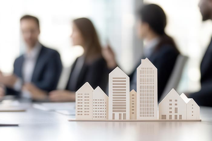 buildings made of blocks with individuals talking in the background