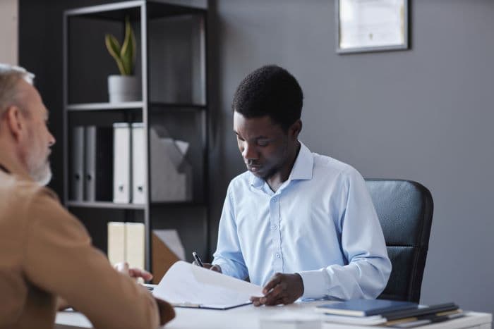A man reviewing a commercial lease with a tenant
