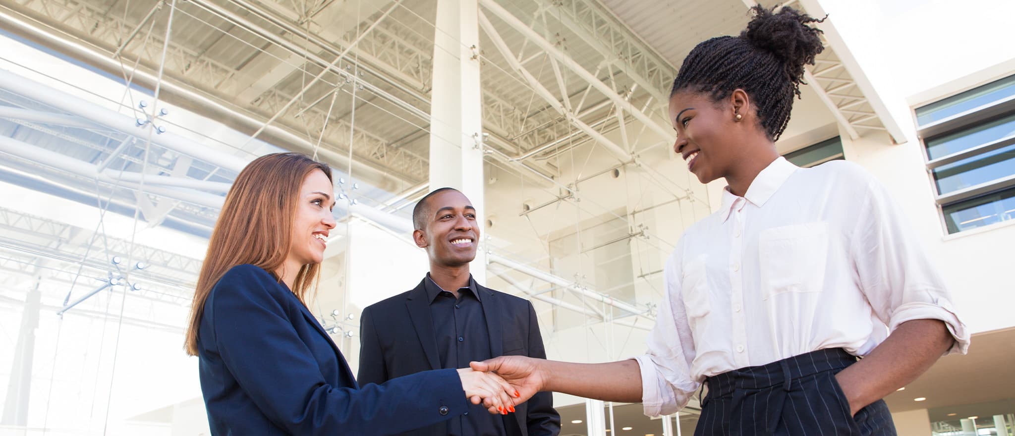 A real estate broker shaking hands with a client