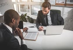 Two men having a conversation in an office space