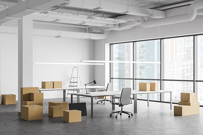 Inside an empty office space with boxes for moving