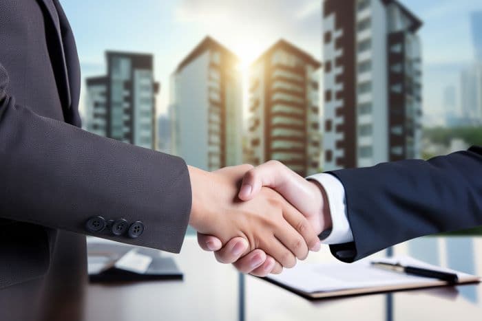 Two individuals shaking hands following an agreement