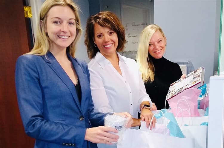three females posing and smiling