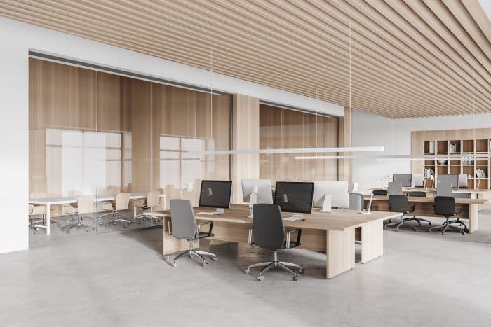 Interior of a modern commercial office space with a conference room in the background