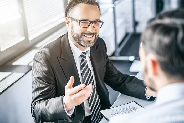 Two men talking in a conference room