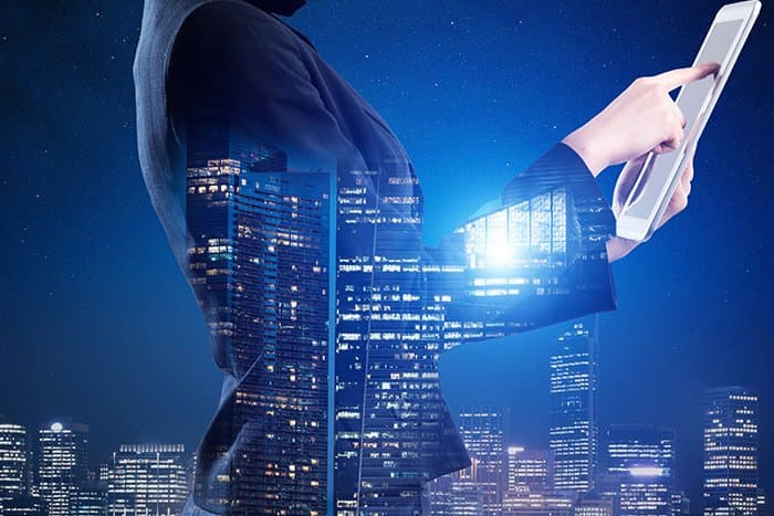 Person on a tablet with an overlay of a skyline
