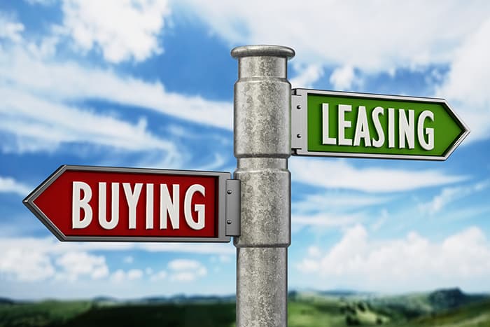Street sign with one side pointing to buying and the other pointing to leasing