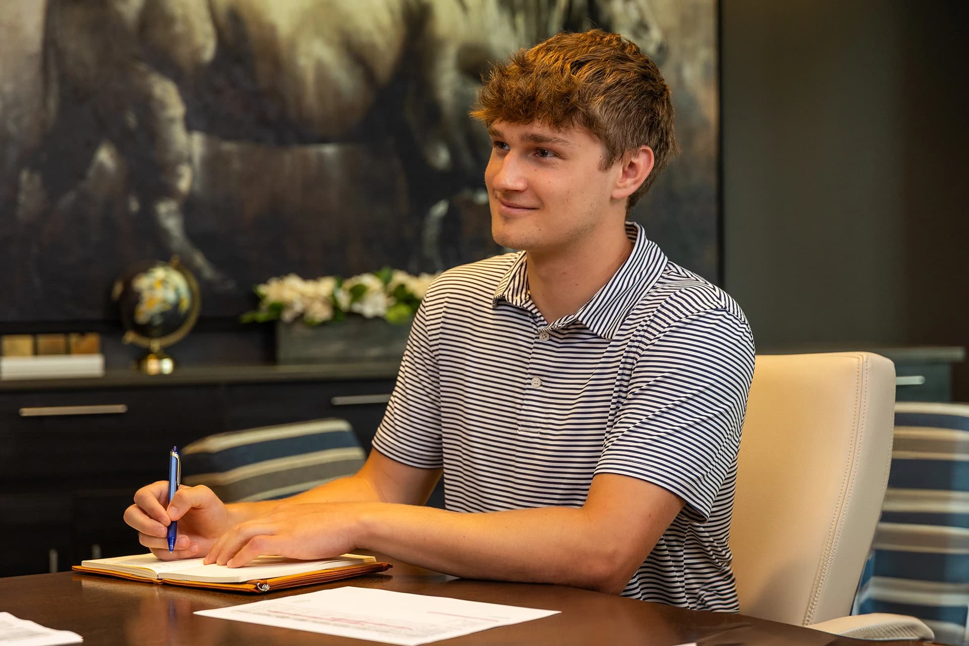 A young man writing in a notebook