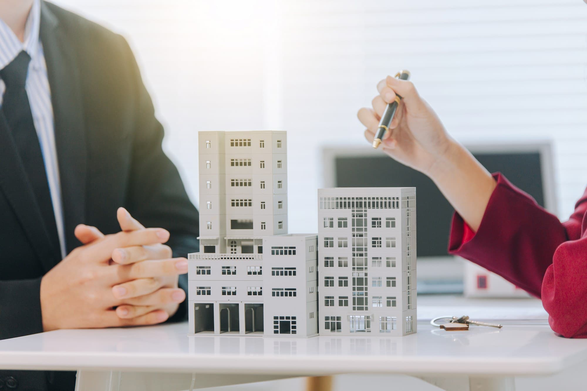 two individuals discussing a rendering of a commercial property