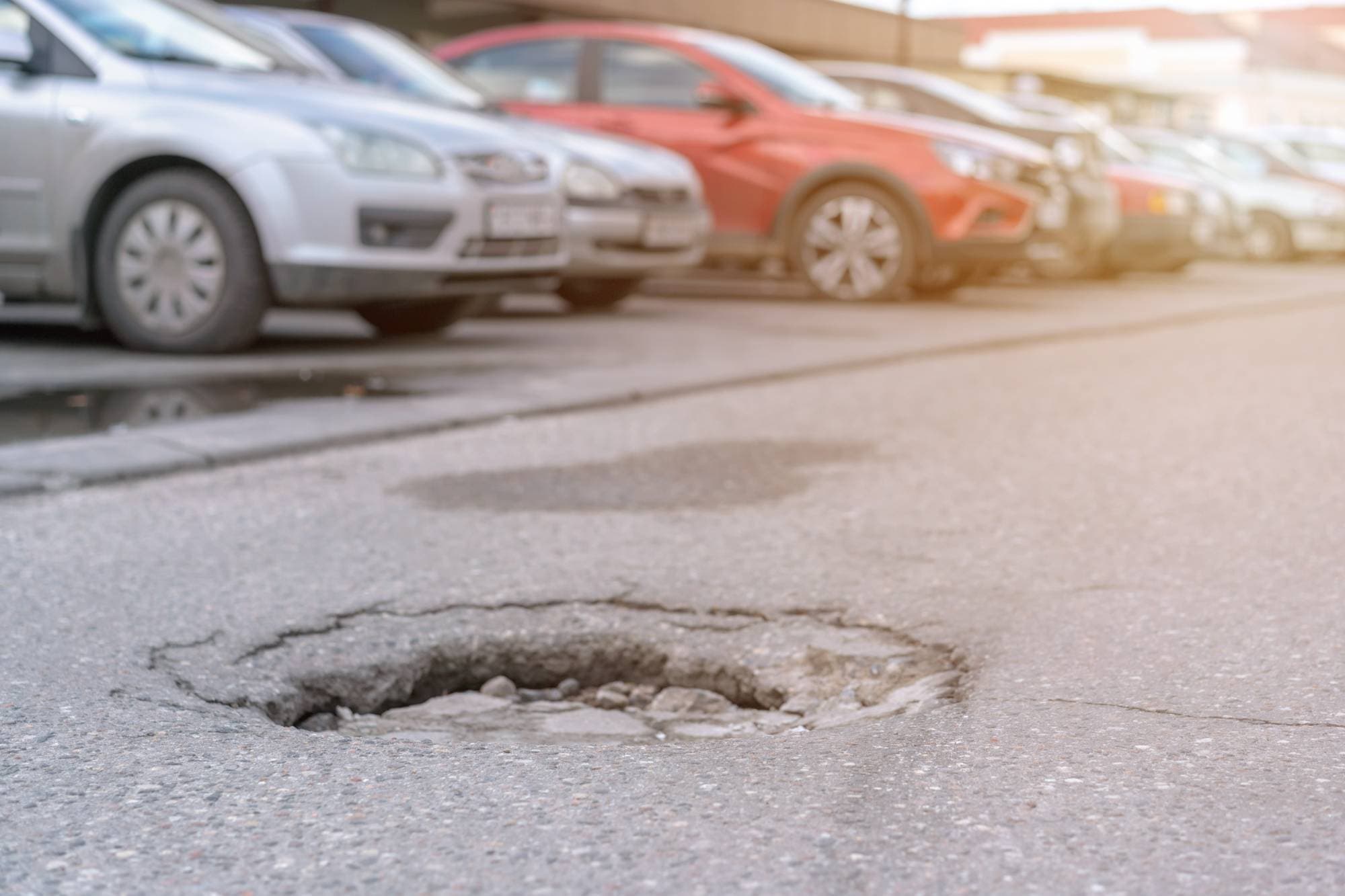 a pot hole in a commercial building parking lot