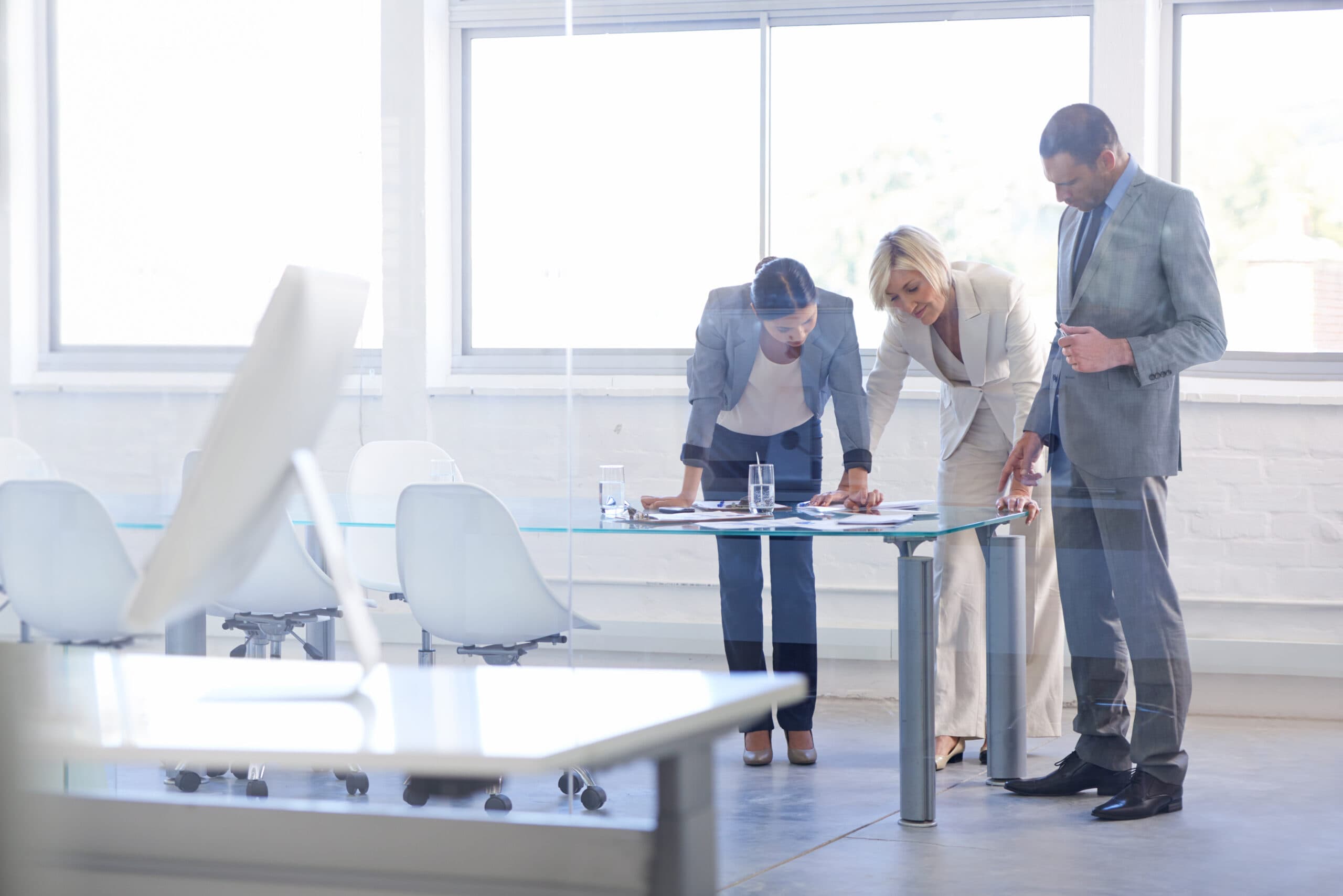 Two women and one man talking about commercial property in a conference room