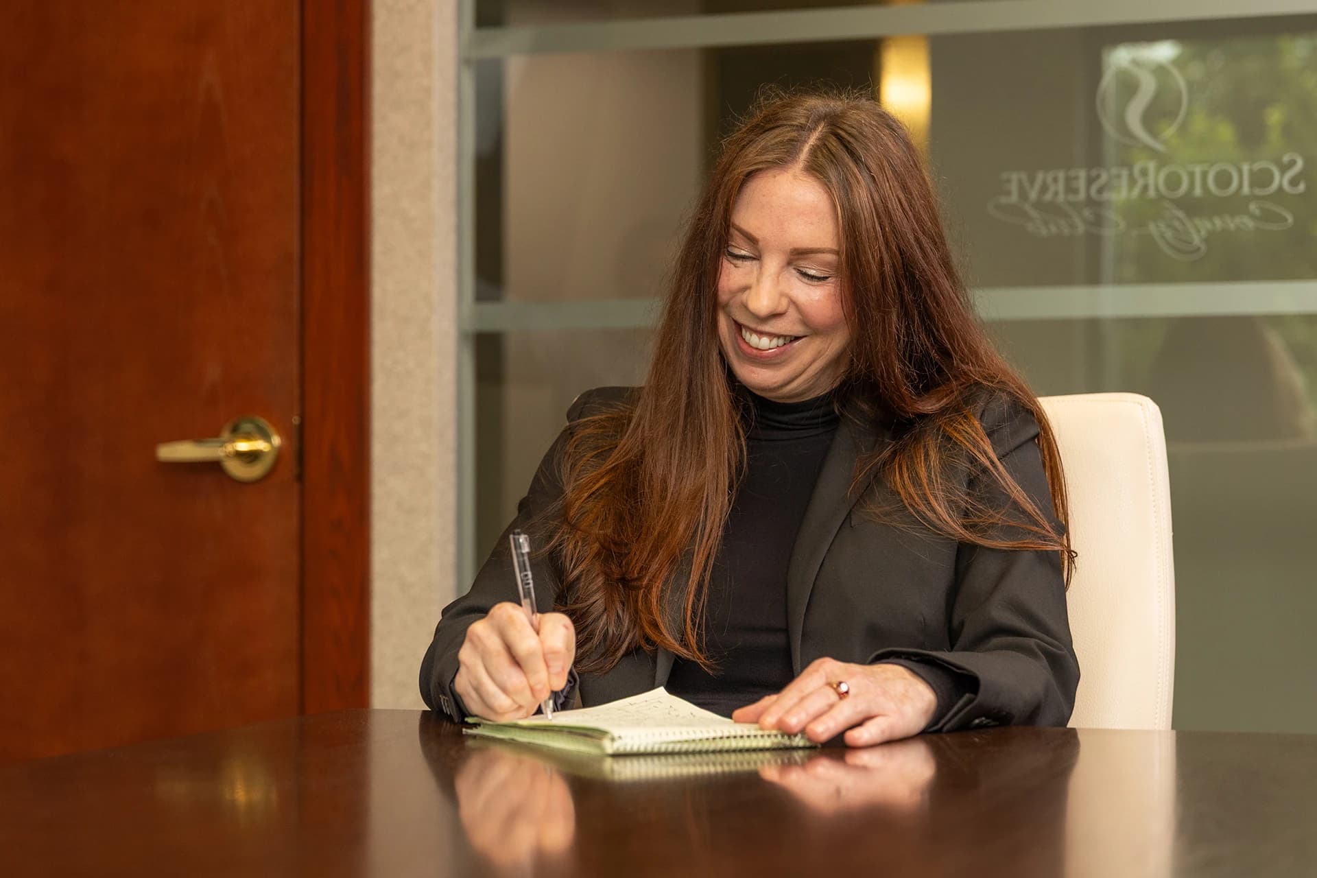 Woman writing on a notepad