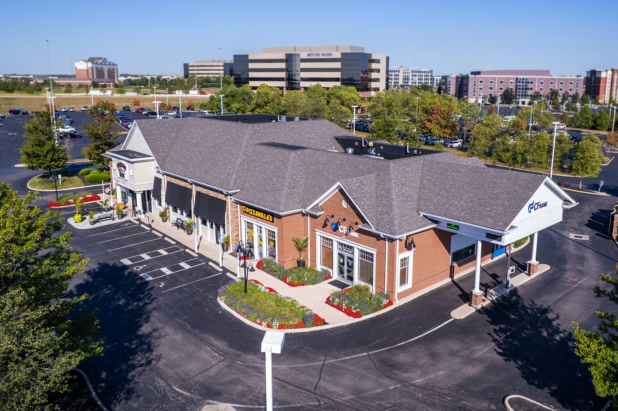 aerial view of commercial storefronts in a plaza