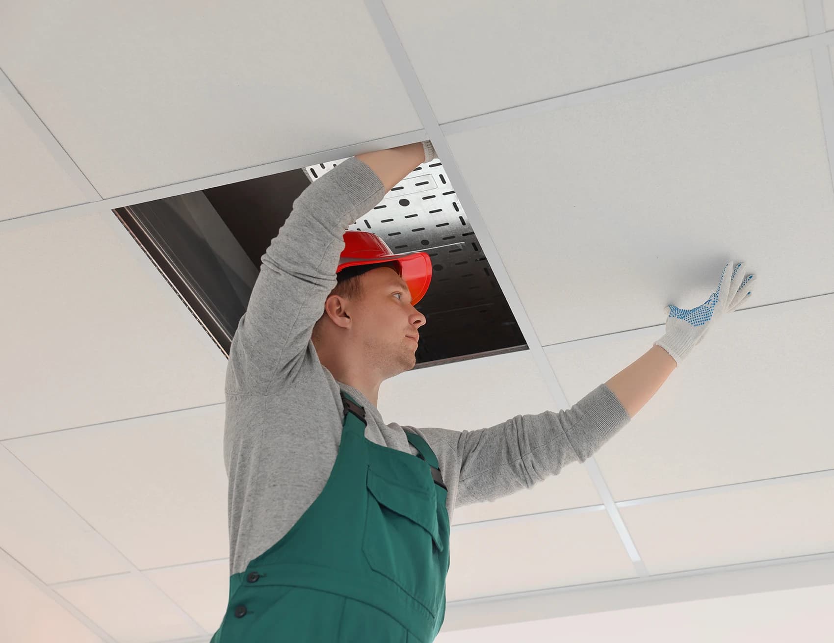 man doing property maintenance on the ceiling