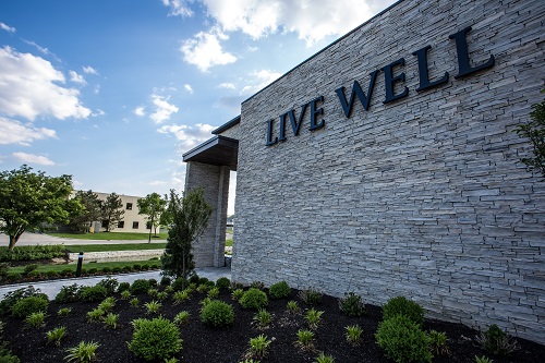 "Live Well" sign on exterior of office building