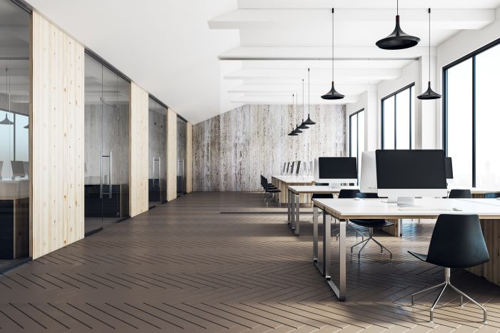 Interior of a rented office space with meeting rooms, desks and computers.