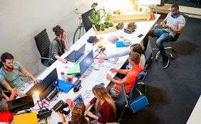 office of employees sharing long desk