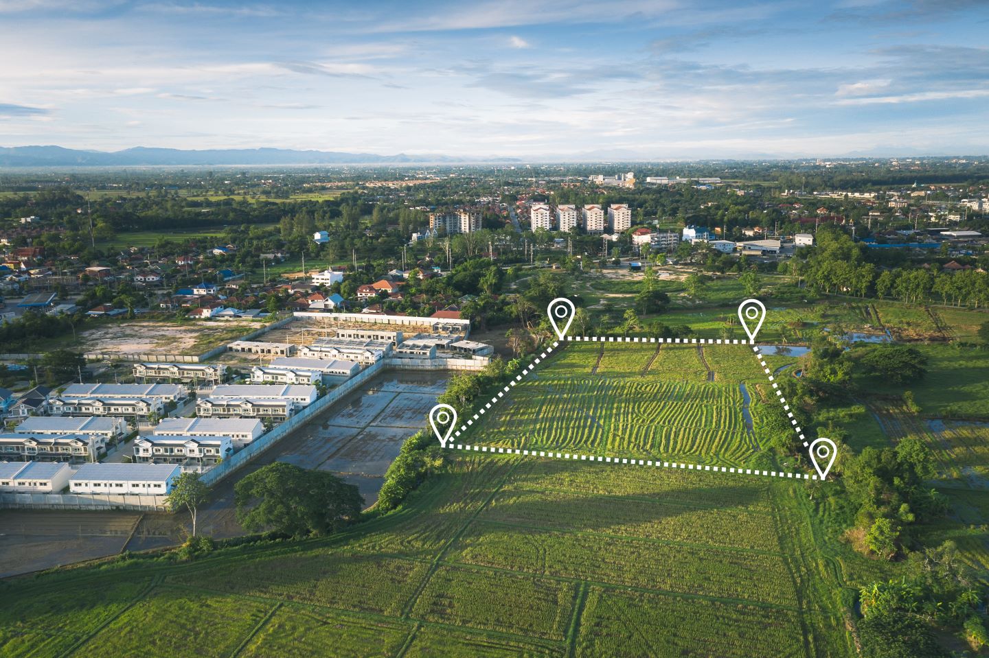 Image of Commercial Real Estate illustrating basics of site selection. Edited image shows shows the boundaries of a vacant commercial property superimposed over aerial photography of the actual site.