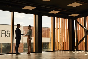 two people shaking hands in building